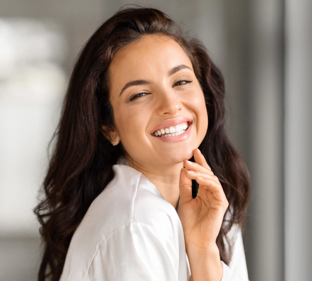 Patient smiling after preventive fluoride treatment for stronger teeth